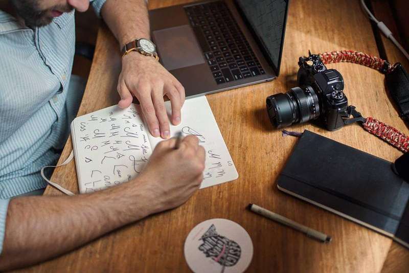 A notebook and pen on a desk for drafting notes