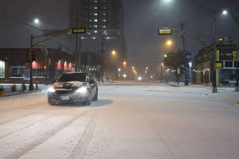 Cars covered in snow after a winter storm in Dallas
