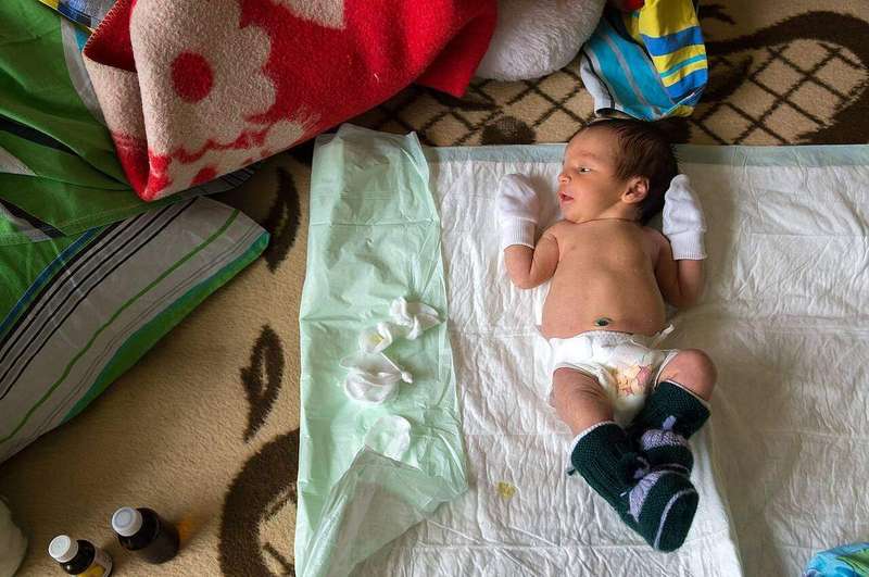 A newborn baby being cared for