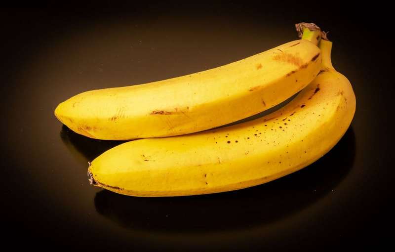 Three bananas on a black background