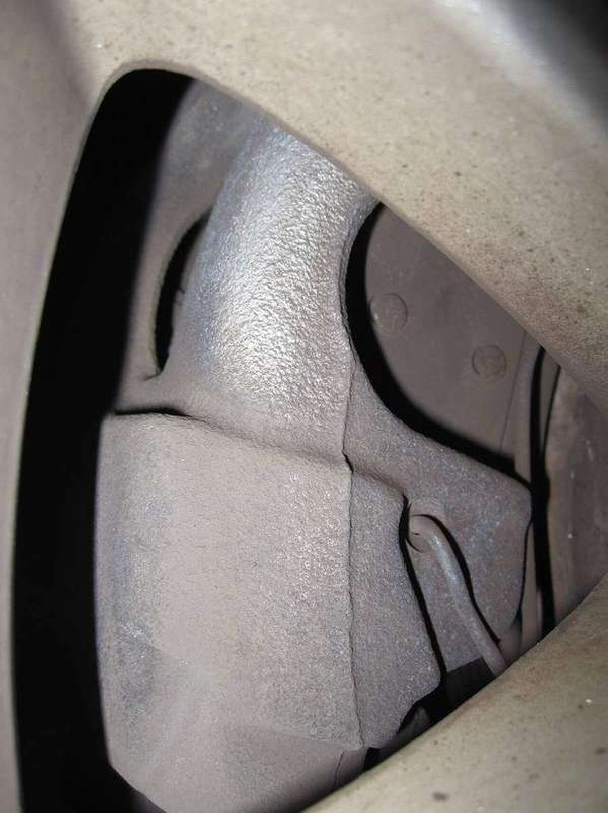 Close-up of a disc brake caliper on a car