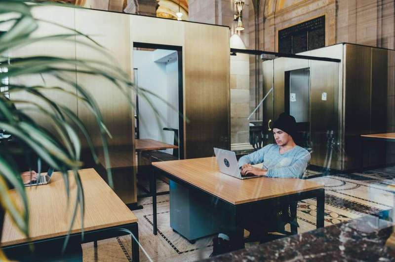 Rows of empty desks in a bright open-plan office