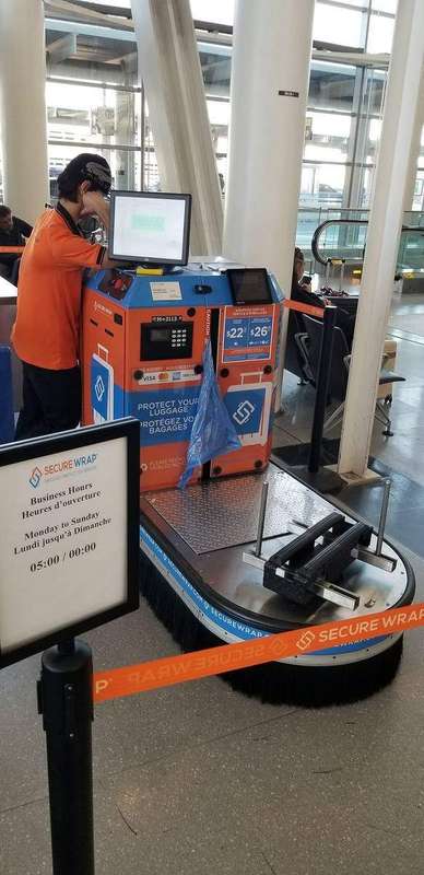 A luggage wrapping station at an airport terminal