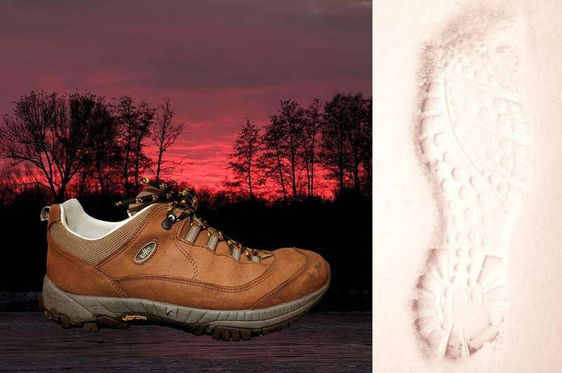 Hiking boots and footprints on a dirt path