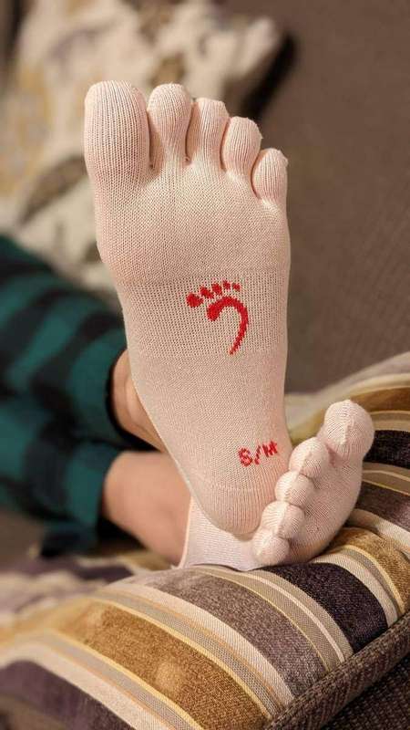 Feet resting with socks on a cushion