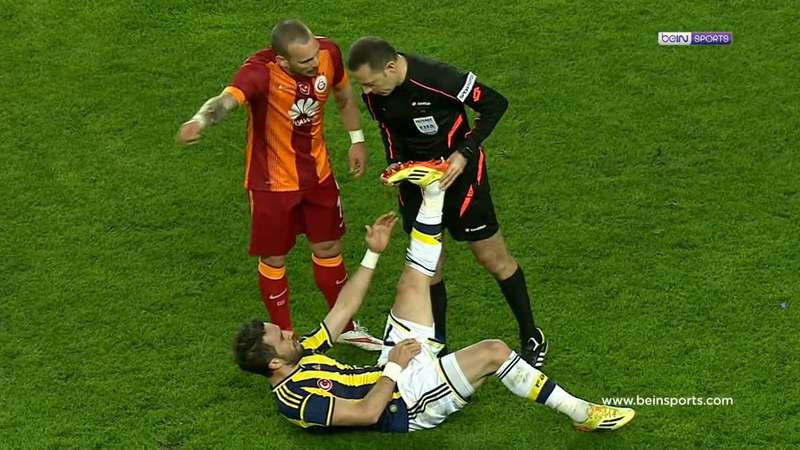 A footballer stretching with cramp during a 2014 derby match