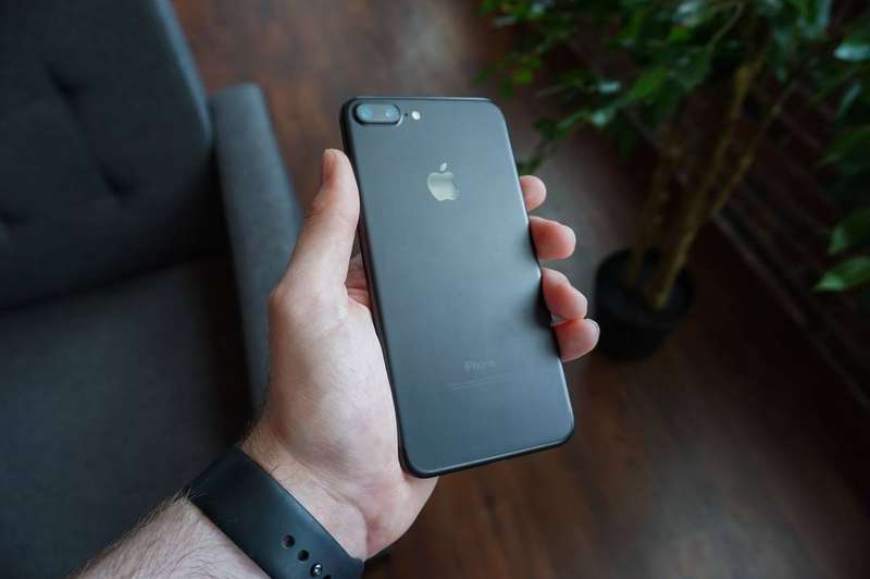 A hand holding a smartphone