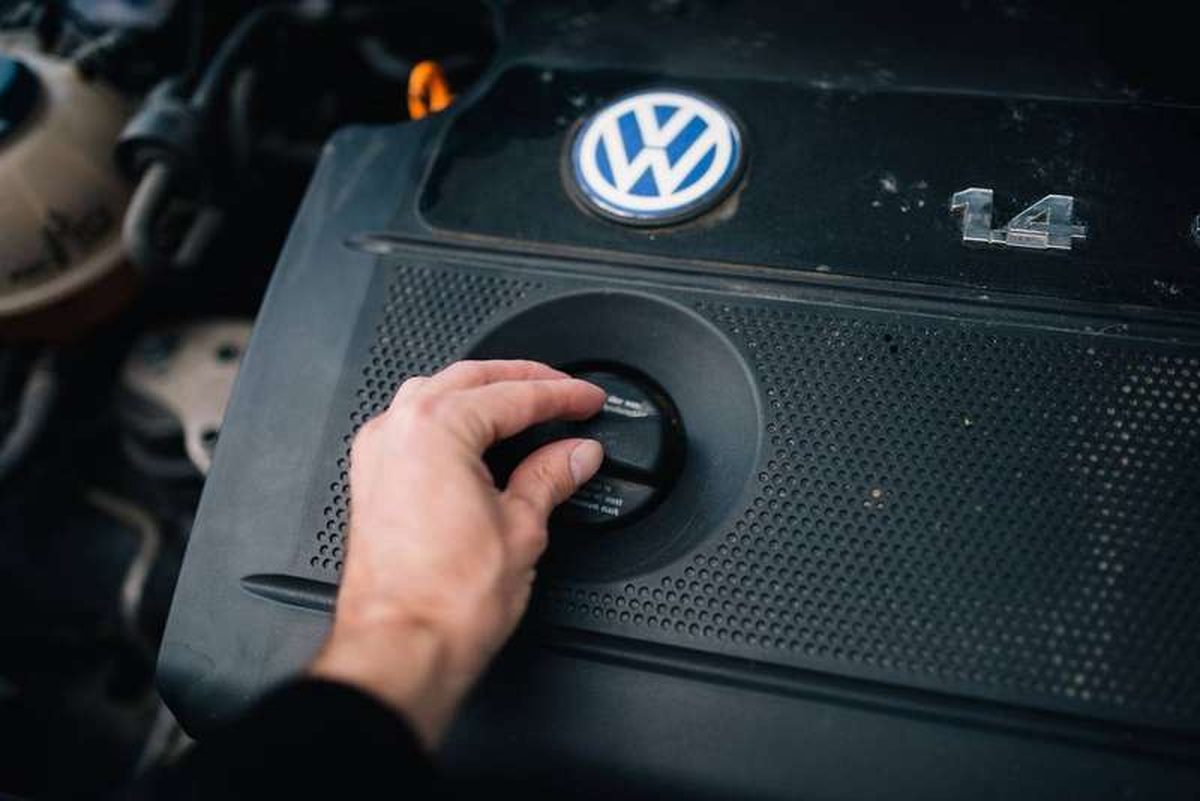A mechanic checking a car's engine oil level