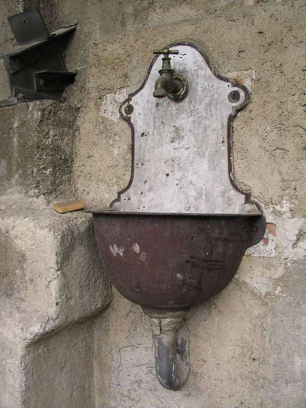 A wash basin with a dripping-style tap, showing where worn seals let water escape