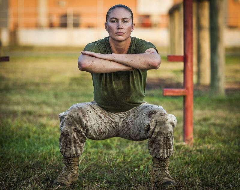 Officer candidates performing bodyweight squats during a physical training event, a good way to practice form before adding weight.