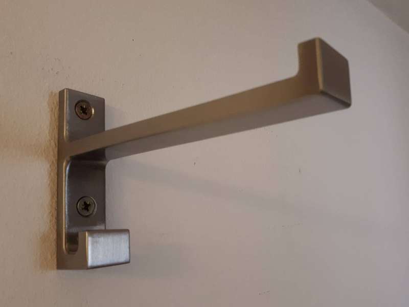 A stainless steel shelf support bracket, the part that transfers the shelf's load into the wall