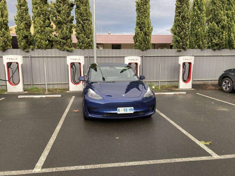 A Tesla Model 3 charging at a Supercharger in Euroa, Victoria