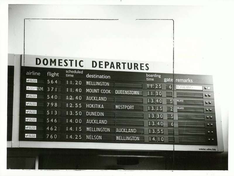 A departure board at an airport showing flight destinations and times