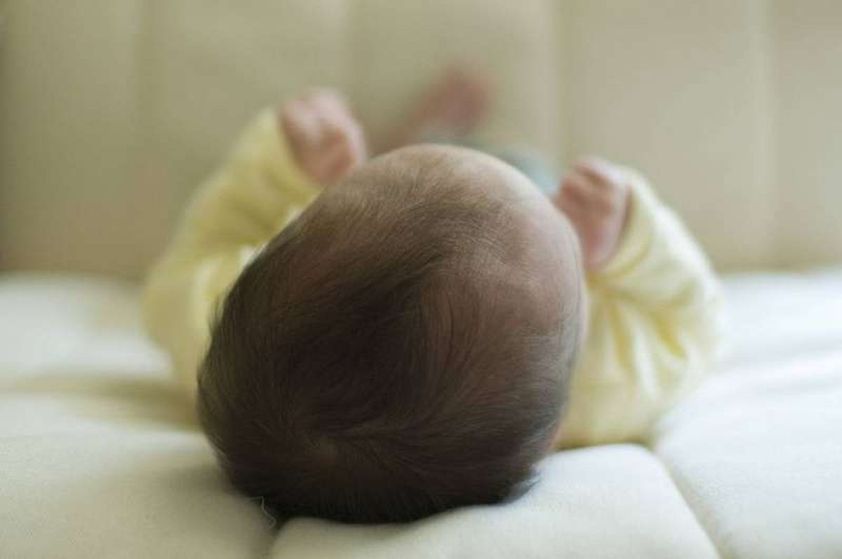 A baby sleeping peacefully in a crib