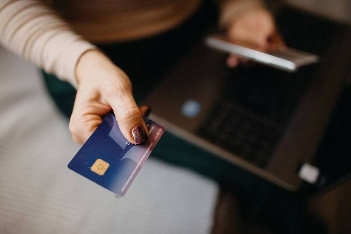 A close-up of a person holding a credit card