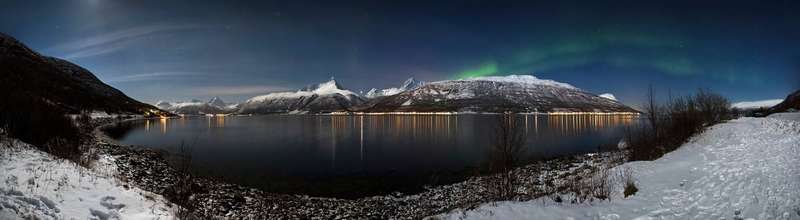 The aurora over Storfjorden and the Lyngen Alps in moonlight