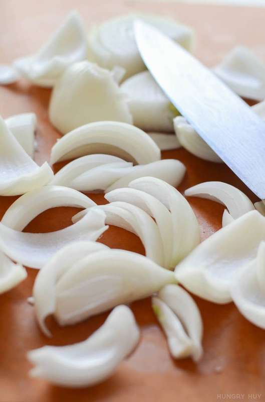 Chopped onions on a cutting board with a knife