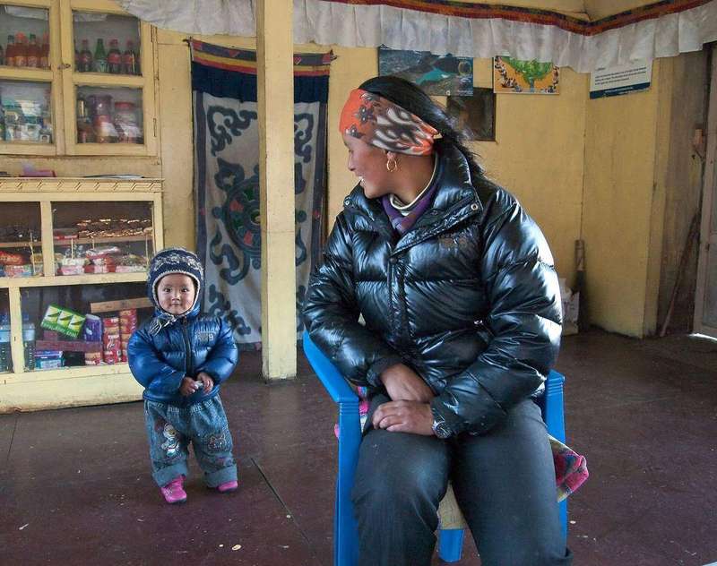 A mother holding her young child close, offering the calm presence that helps a toddler settle.