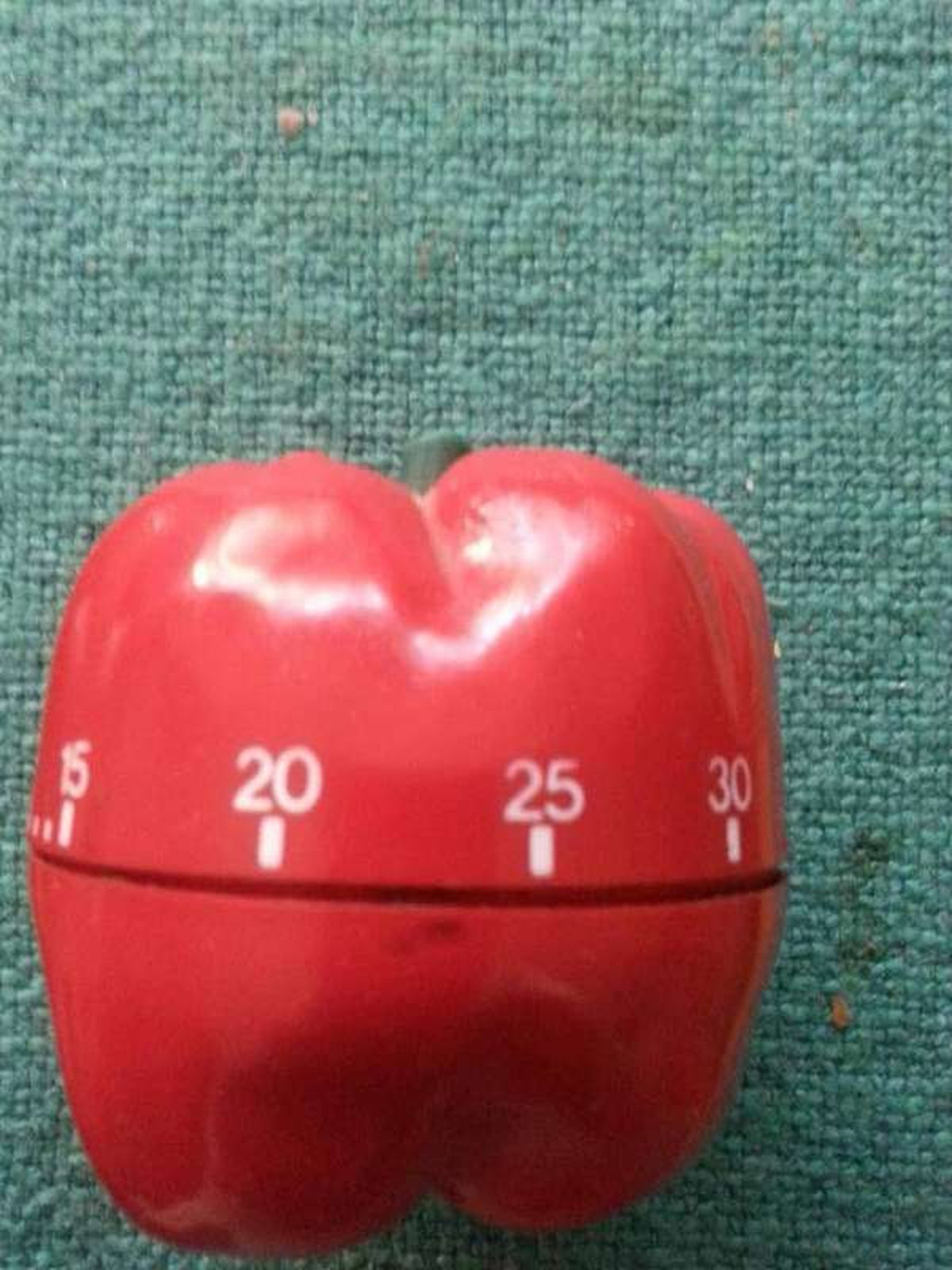 A red pepper-shaped kitchen timer