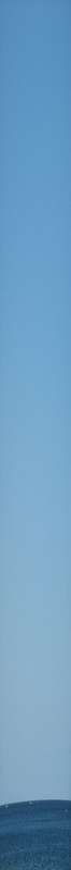 A clear blue sky meeting the horizon, the everyday view Rayleigh scattering creates