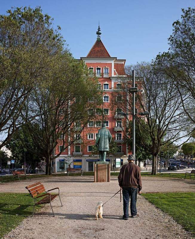 A man walking a dog in a park
