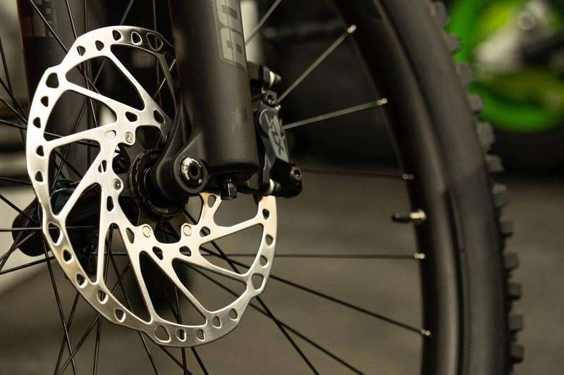 A disc brake rotor and caliper with pads visible