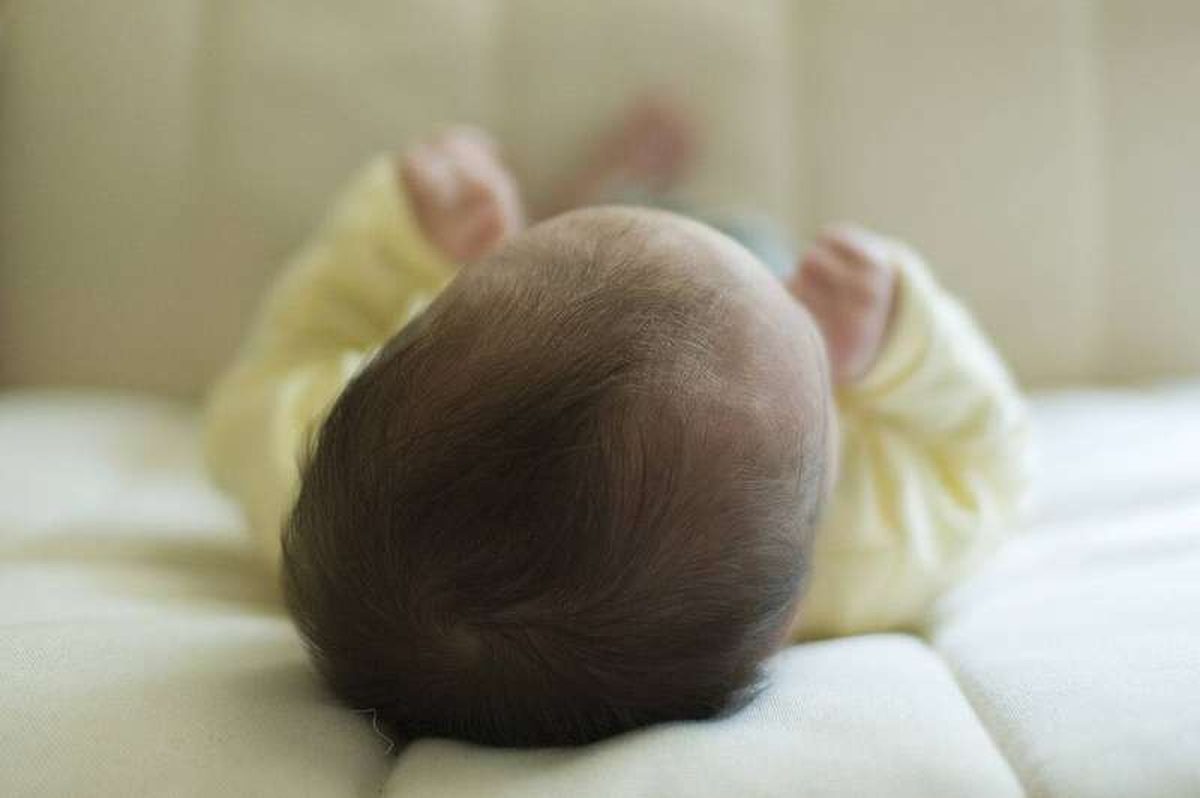 A baby sleeping in a crib