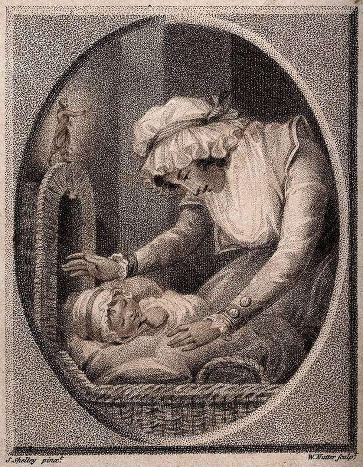 A mother watching over her sleeping baby