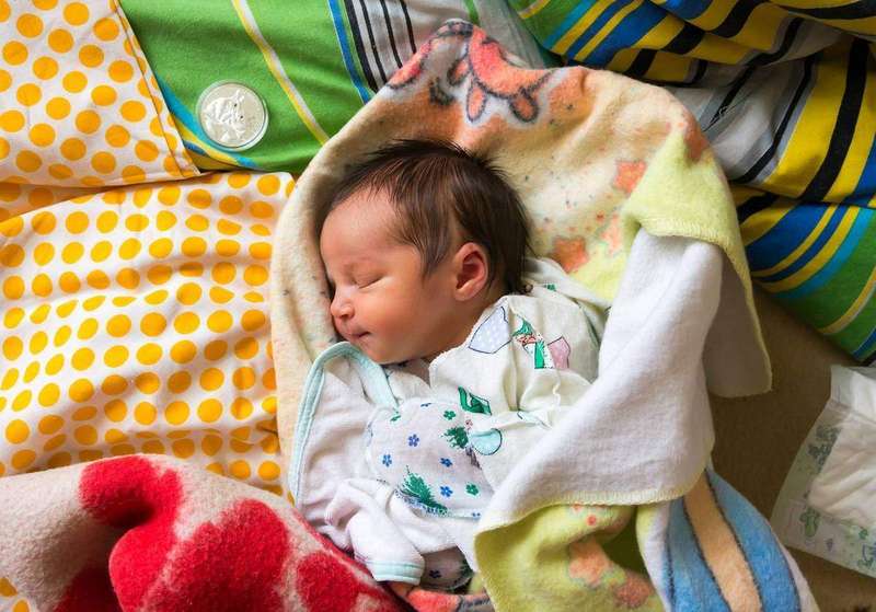 A portrait of a newborn baby girl
