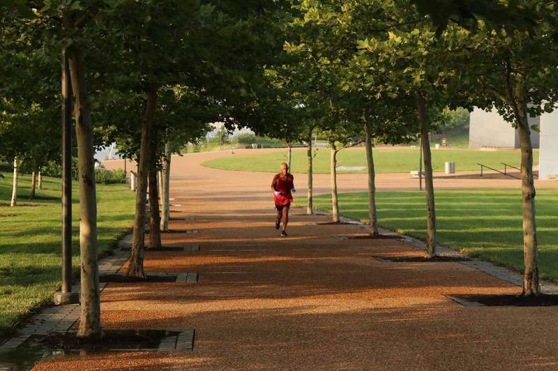 A person jogging outdoors in a park