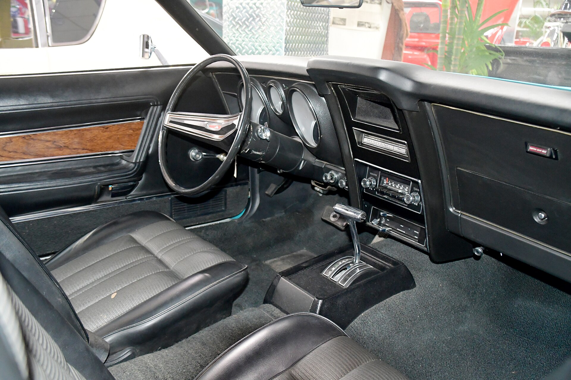A vintage car interior showing the dashboard and windshield