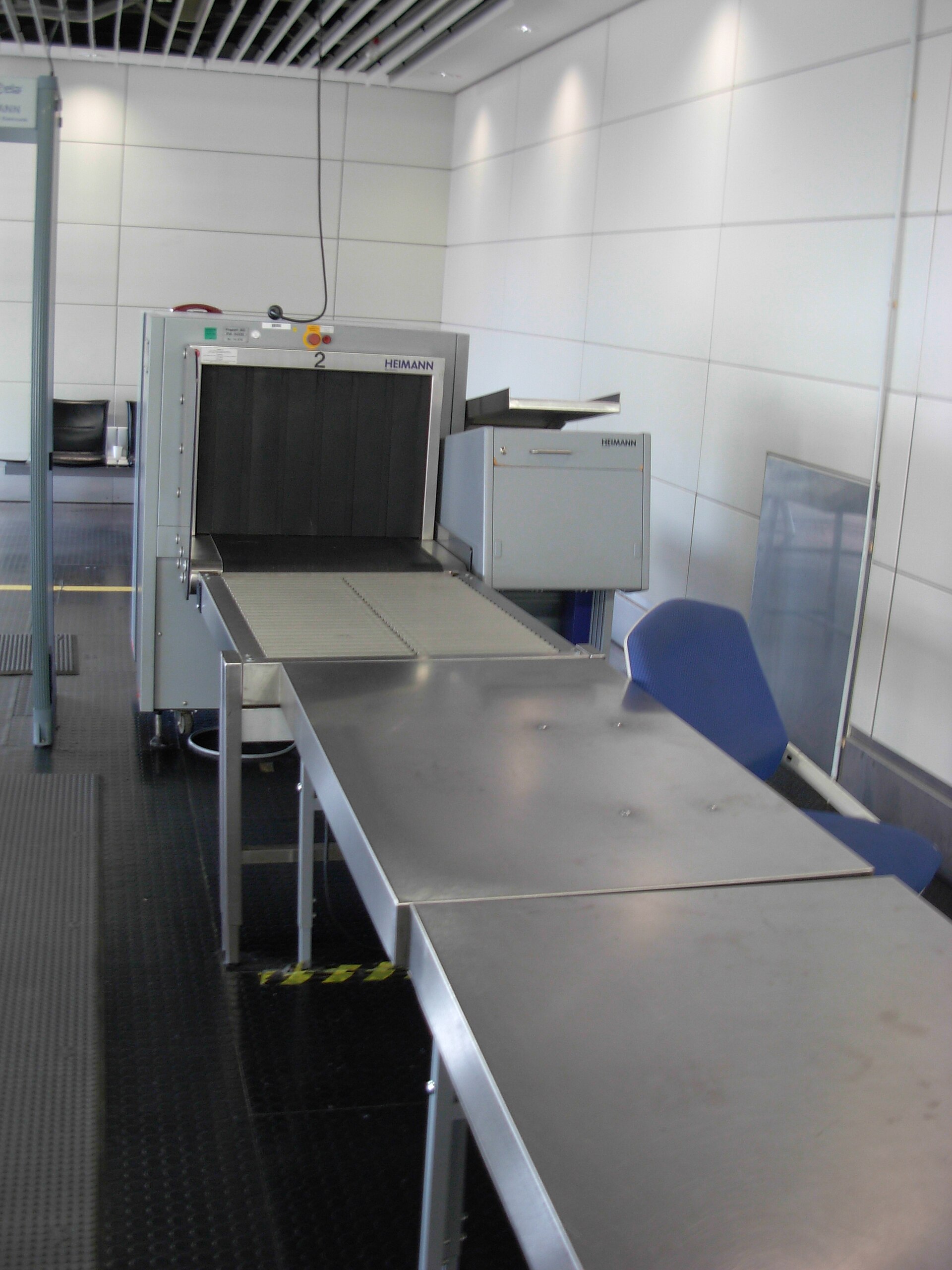 Close view of airport security screening area with X-ray tunnel