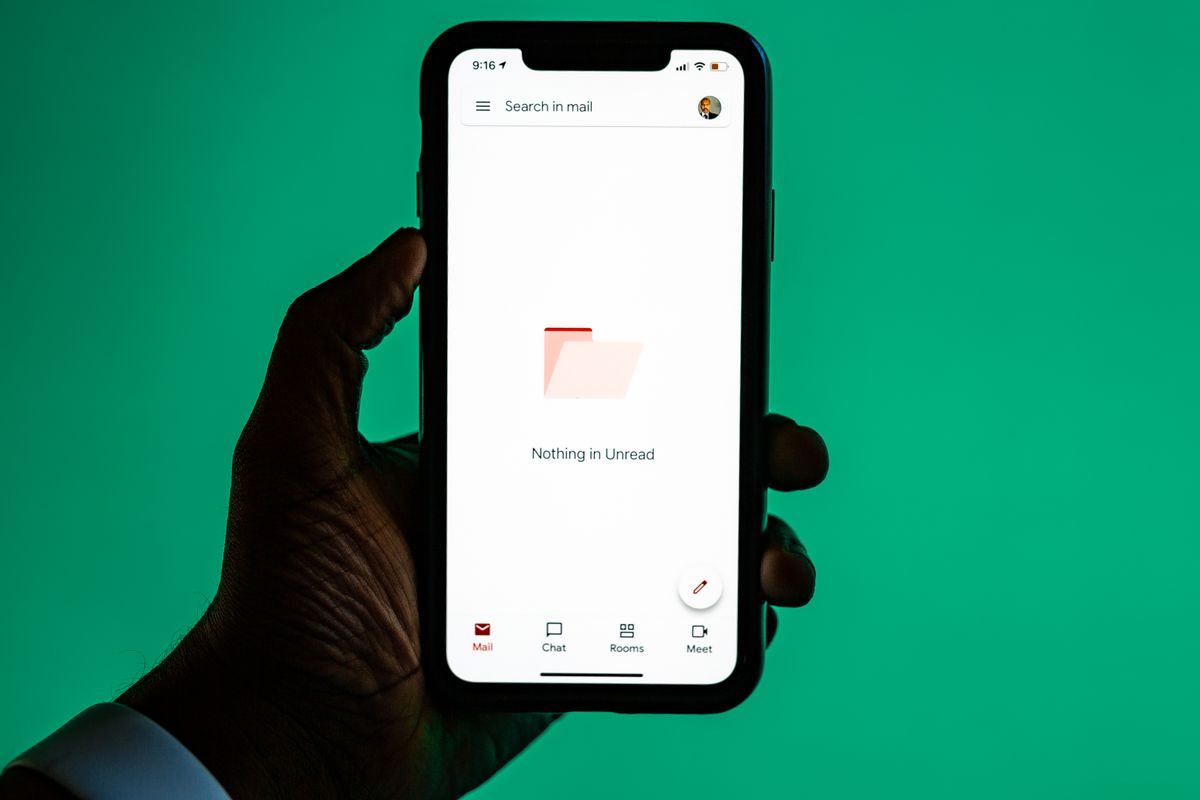 A hand holding a smartphone, the settings app where eSIM profiles are managed