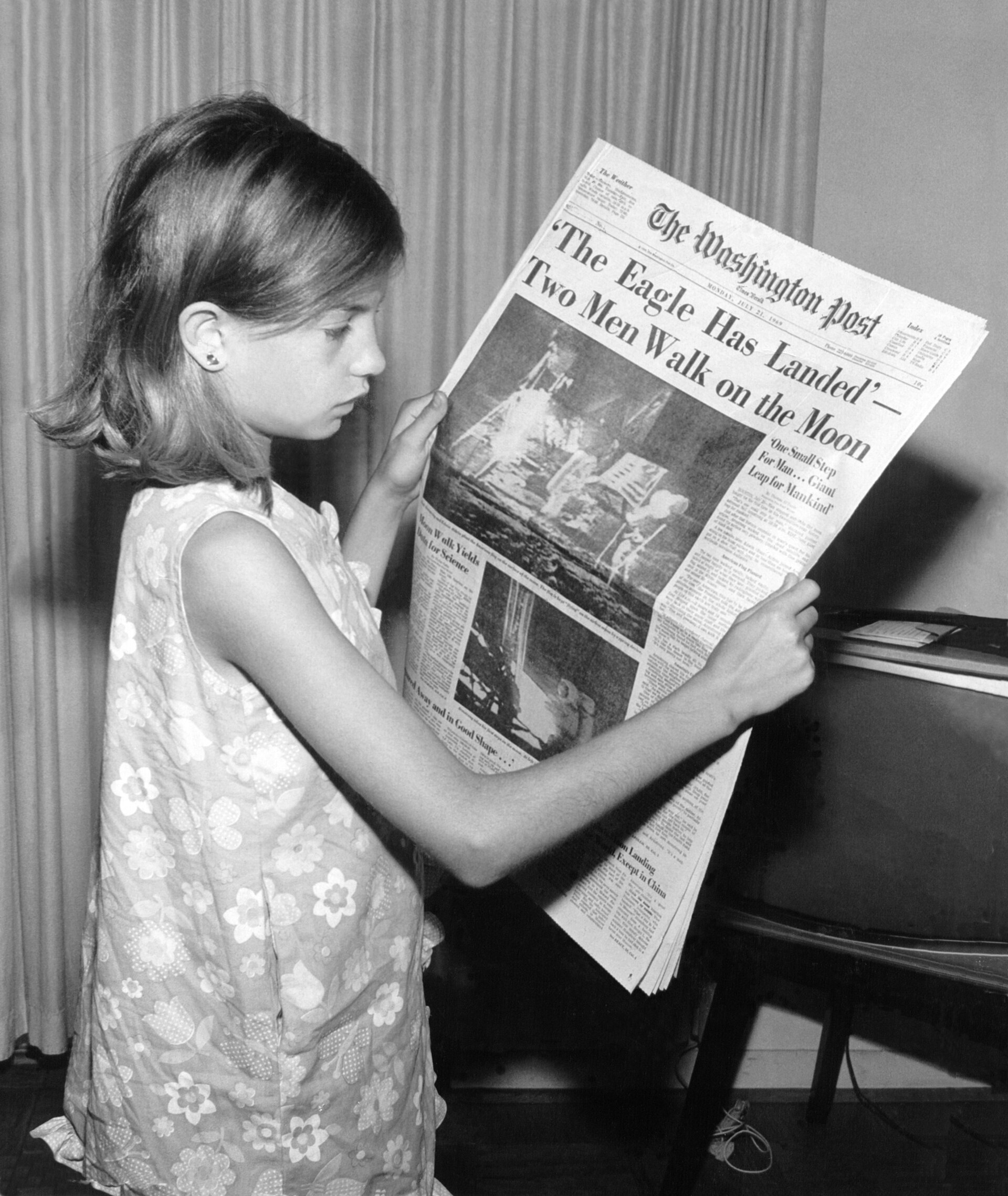 A historic newspaper front page showing the 1969 Moon landing