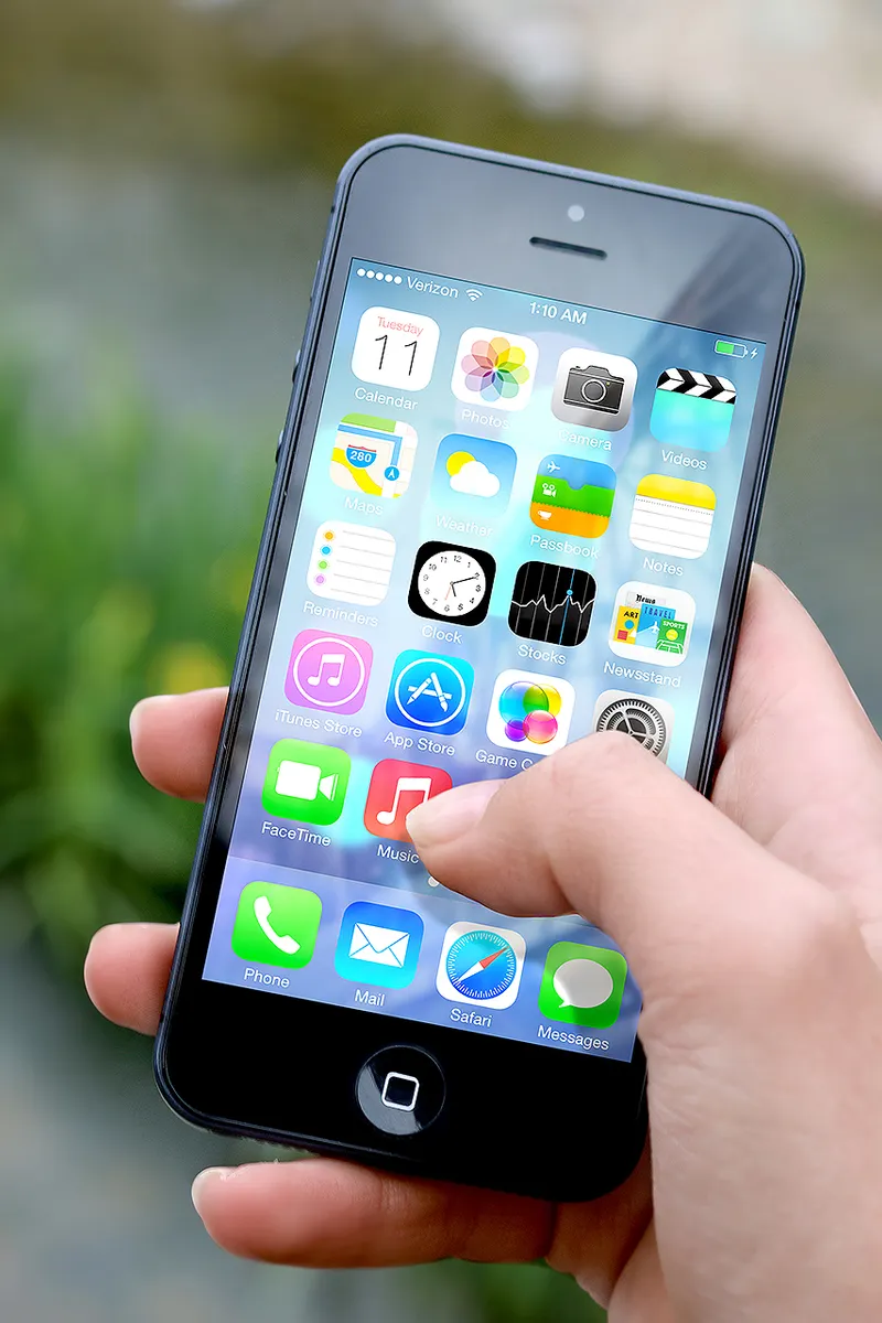 A hand holding an iPhone smartphone