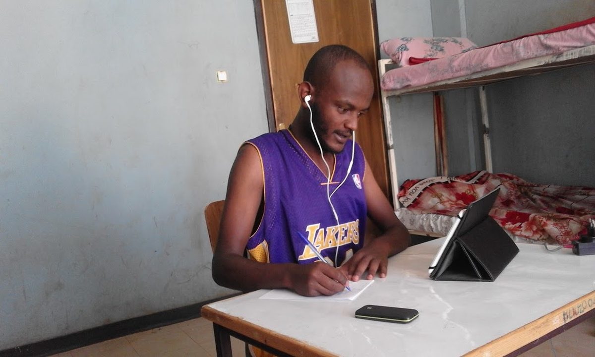 A student studying from a tablet at a dormitory desk
