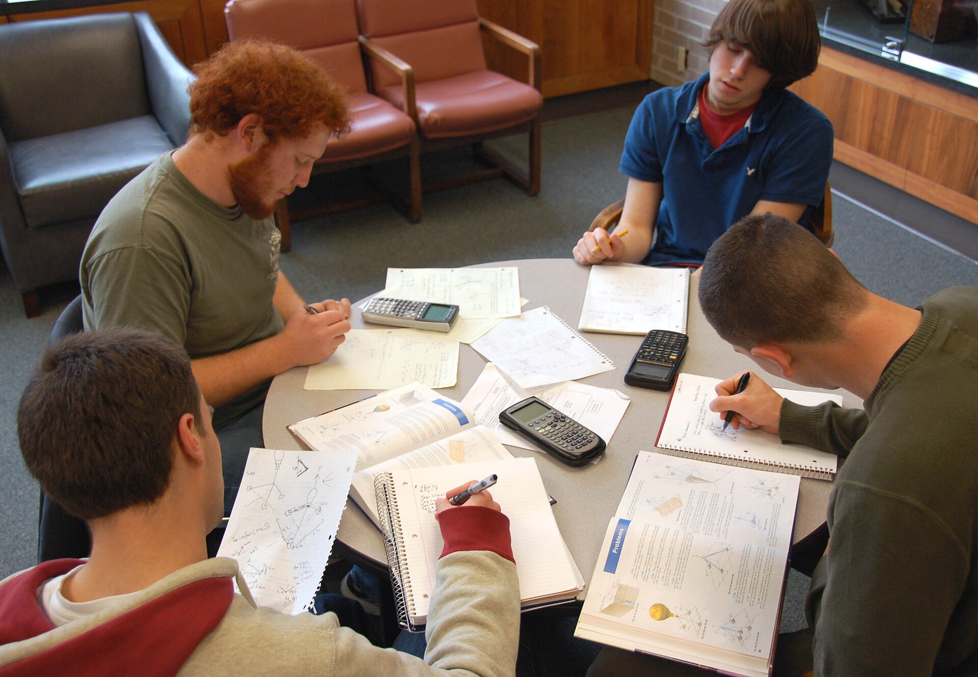 Four university students studying together at a table