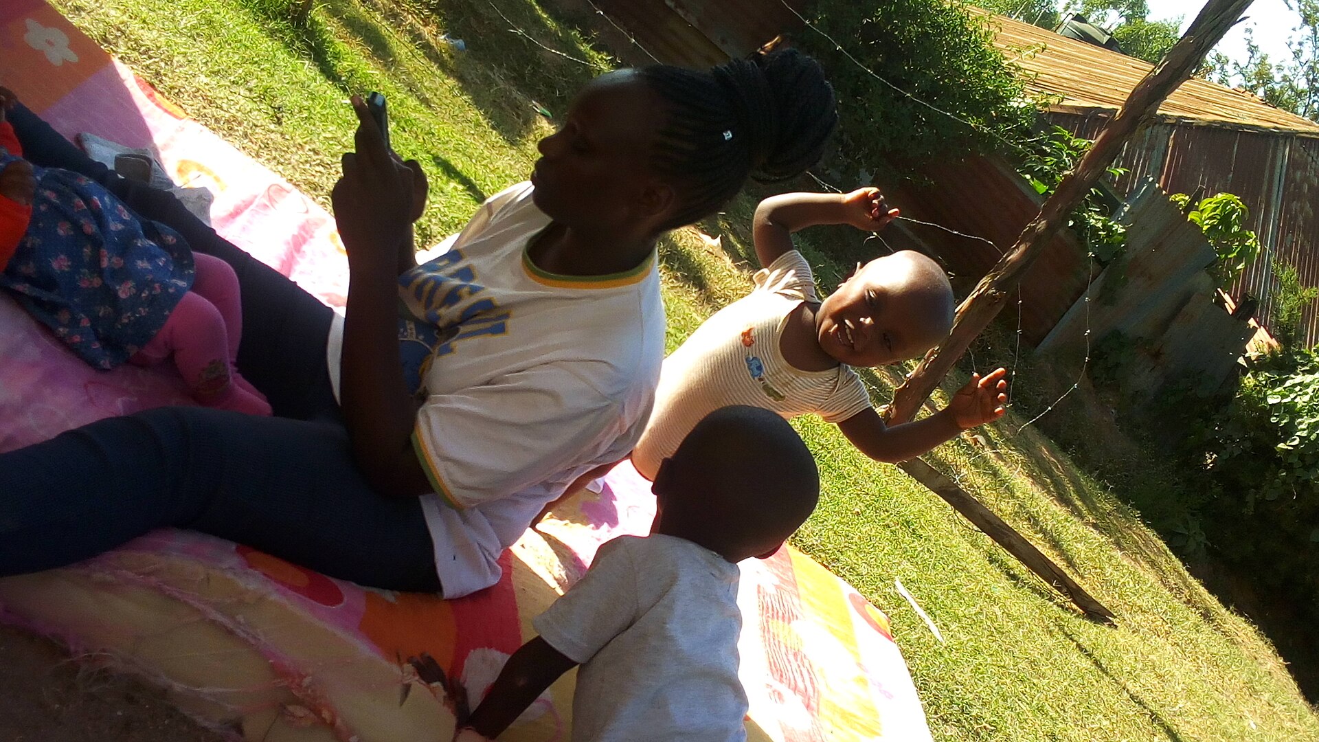 Toddlers playing outdoors with a caregiver