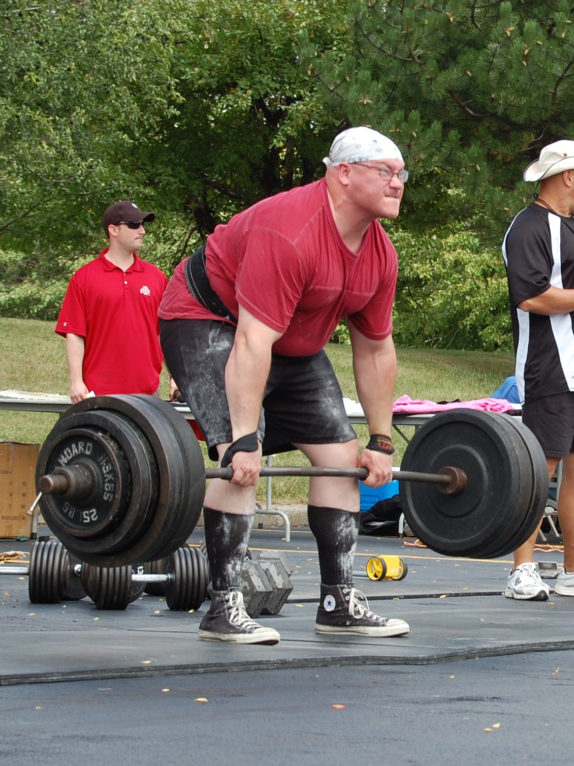 Lifter setting up for a deadlift with a loaded barbell