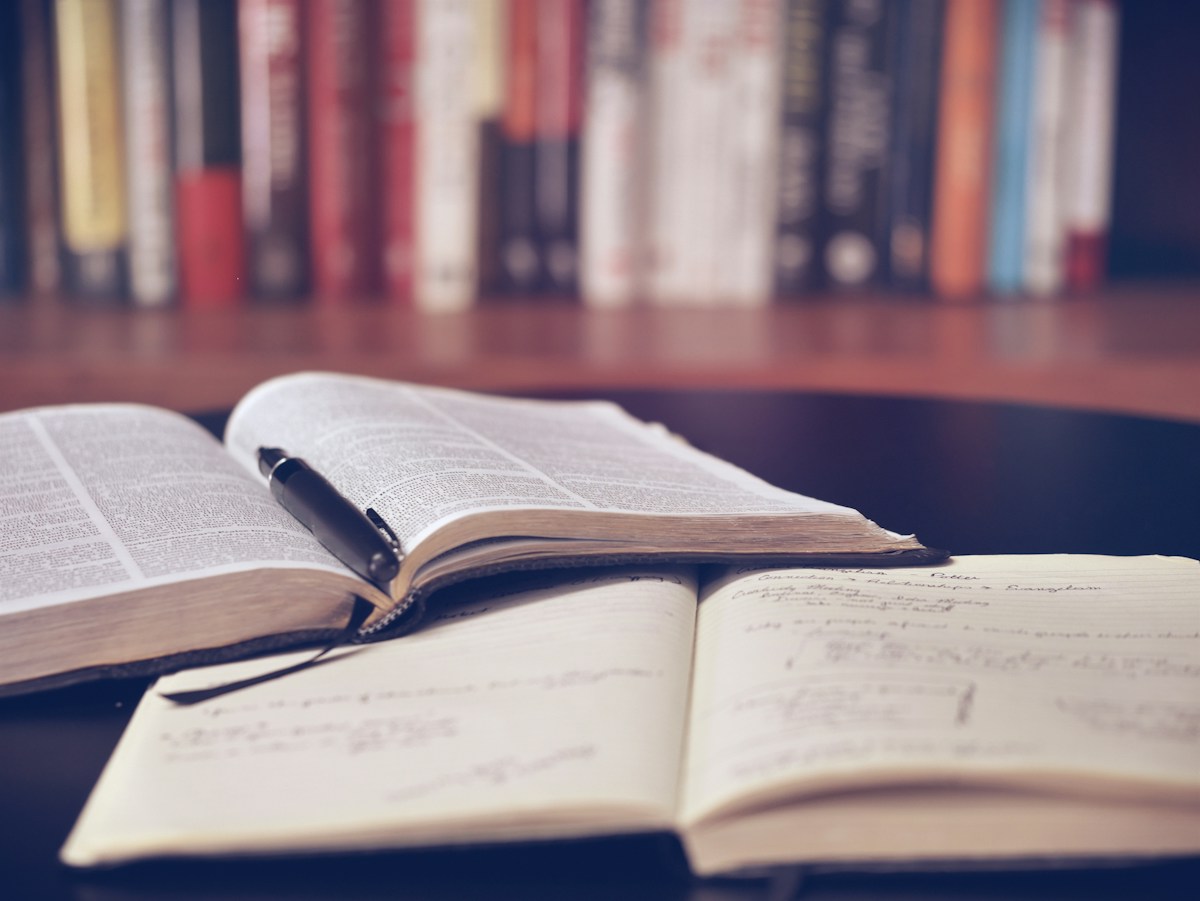 A focused study setup with books and a notebook