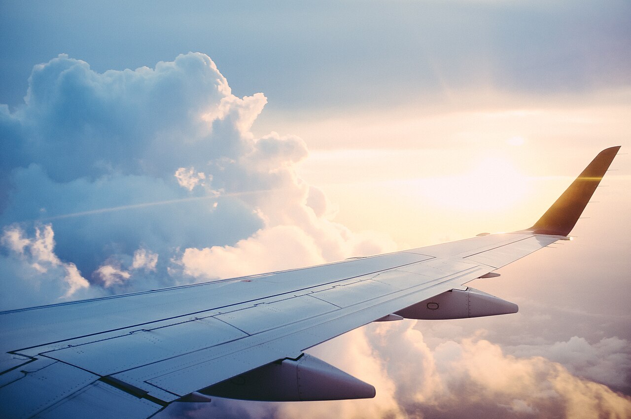 An airplane wing tip seen from a passenger window