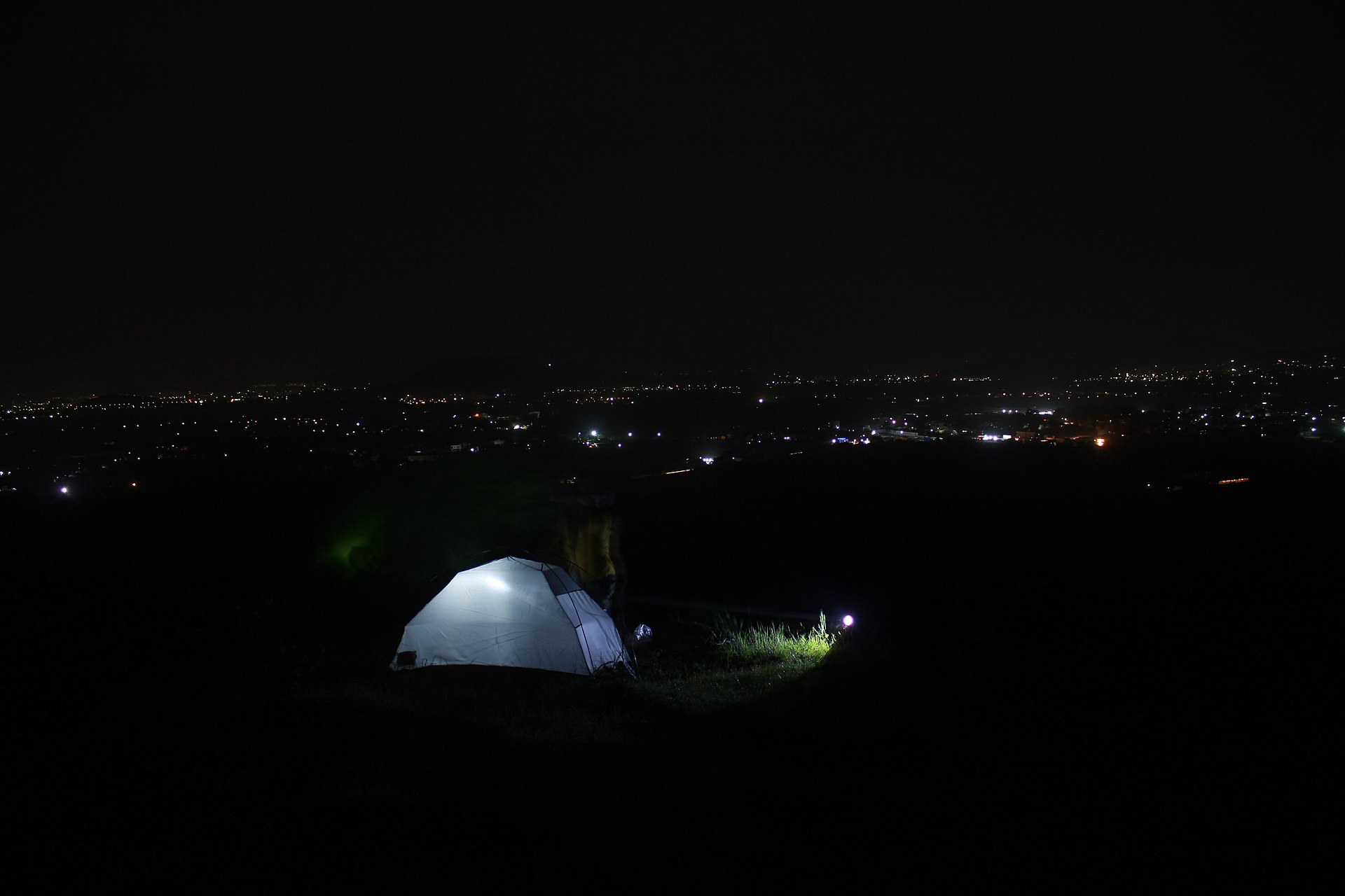 Another view of a tent under the night sky at a campsite