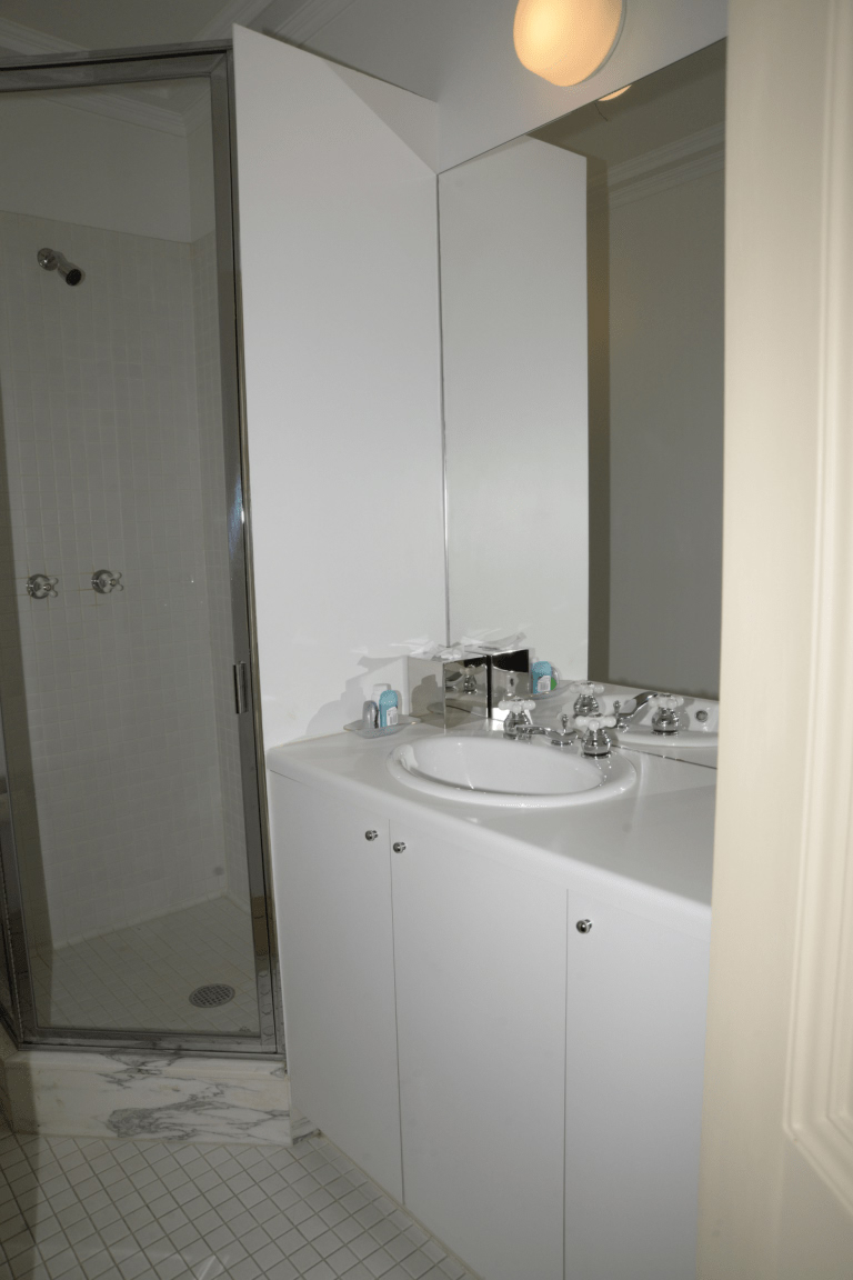Modern bathroom with tiled floor and glass shower enclosure