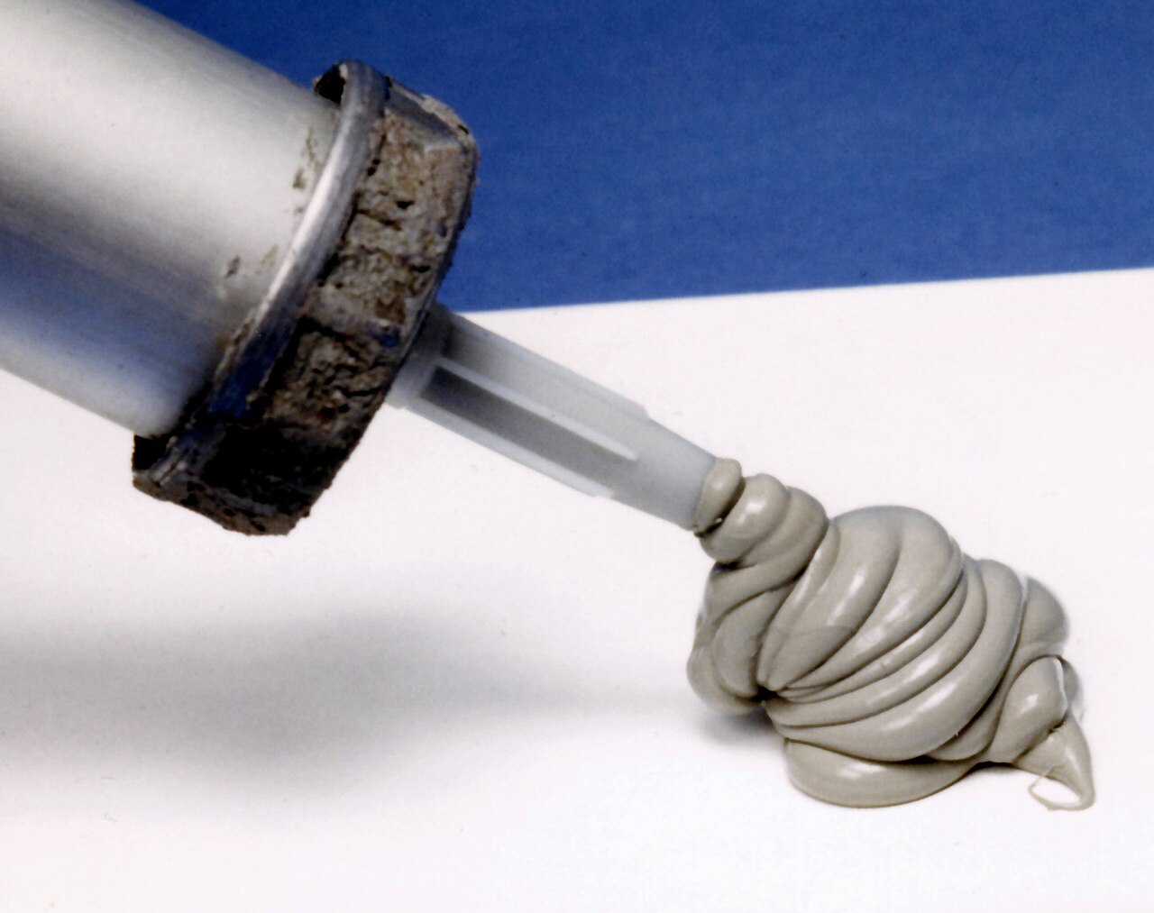 Caulk being applied with a caulking gun
