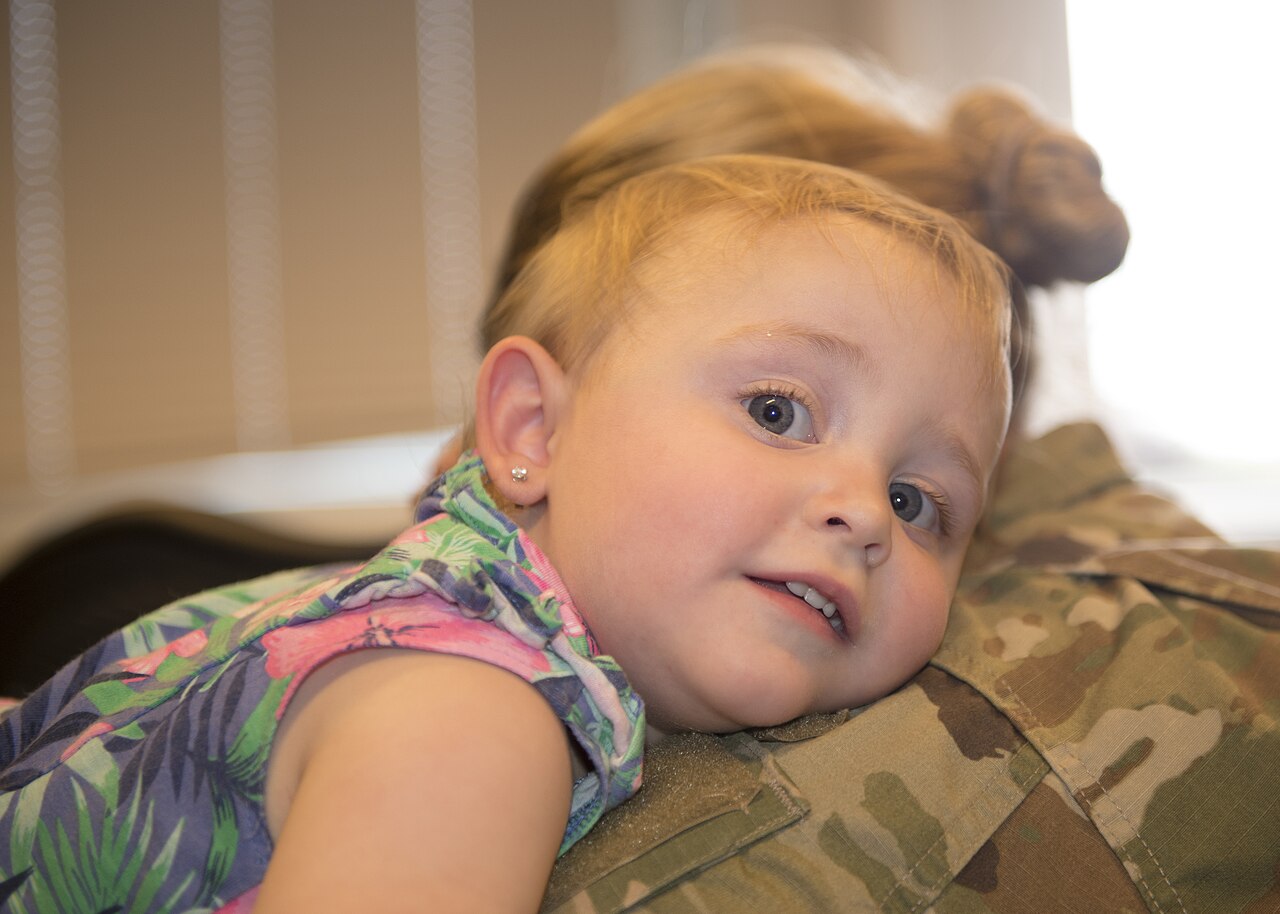 A young child hugging her mother, an example of the close contact at the heart of time-in