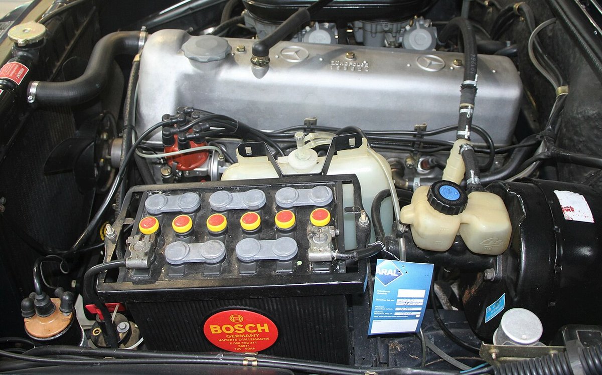 Car battery installed in an engine bay