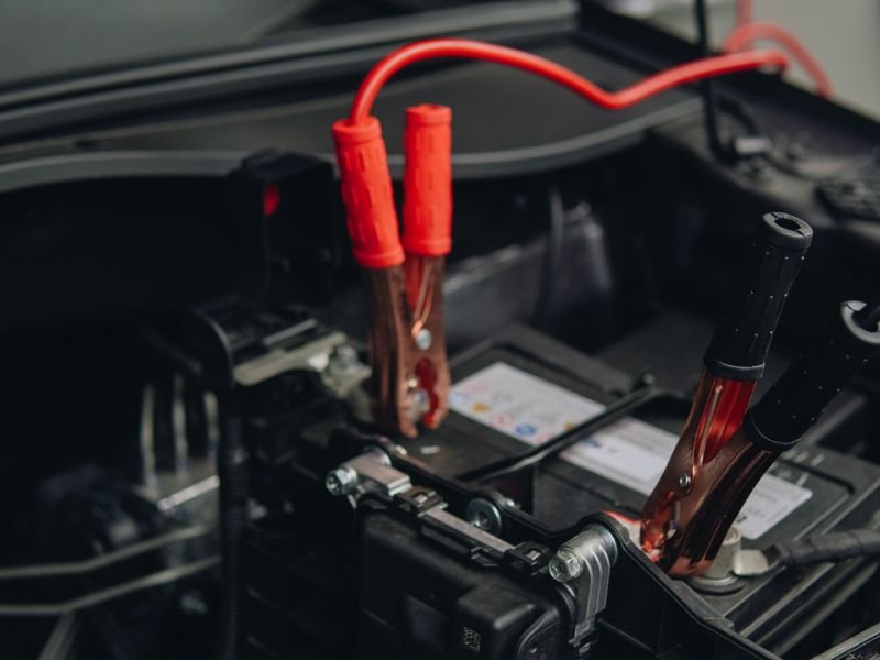 Jumper cables clamped onto battery terminals