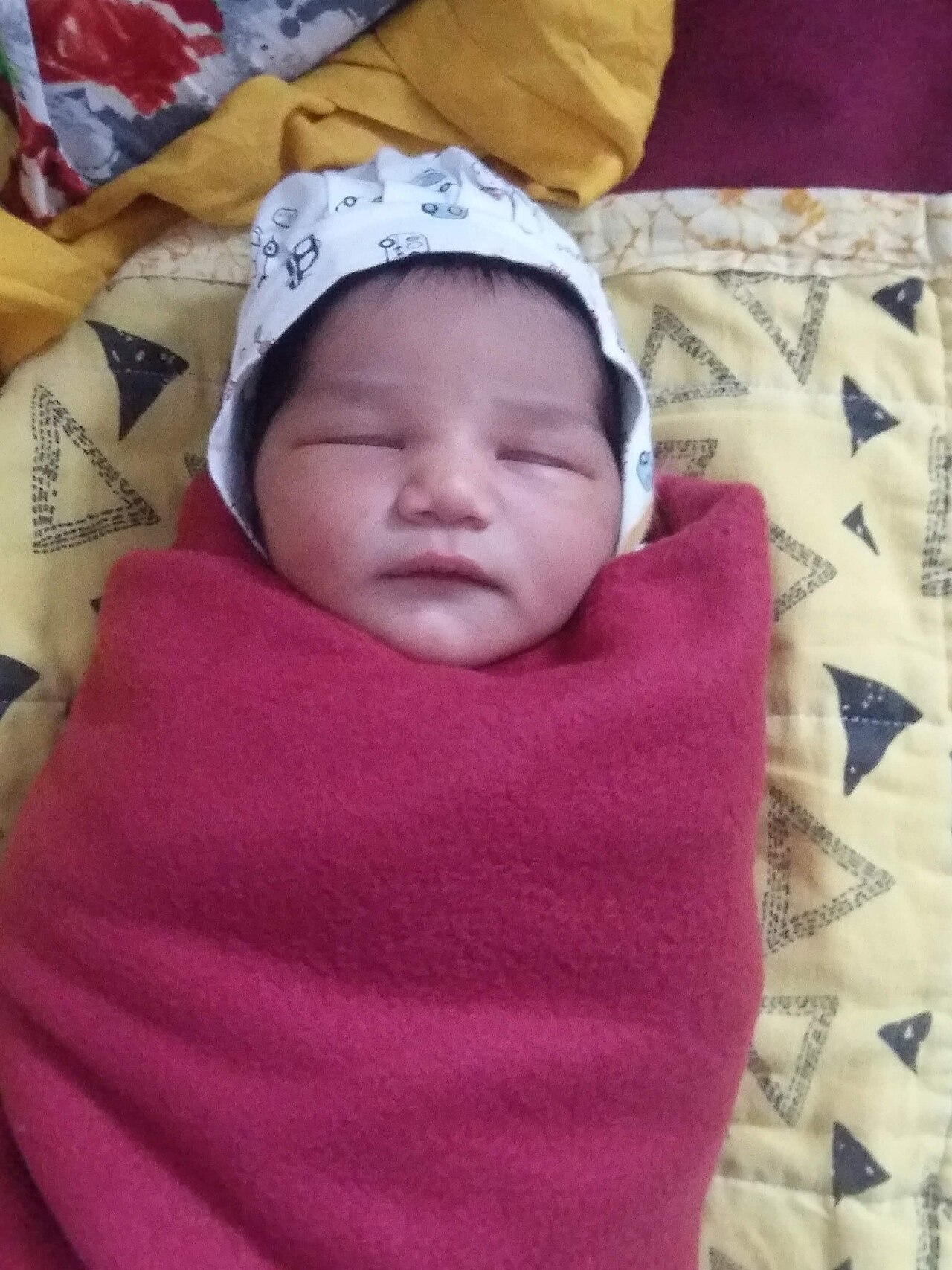 A newborn baby sleeping peacefully, the new arrival the older child is preparing for