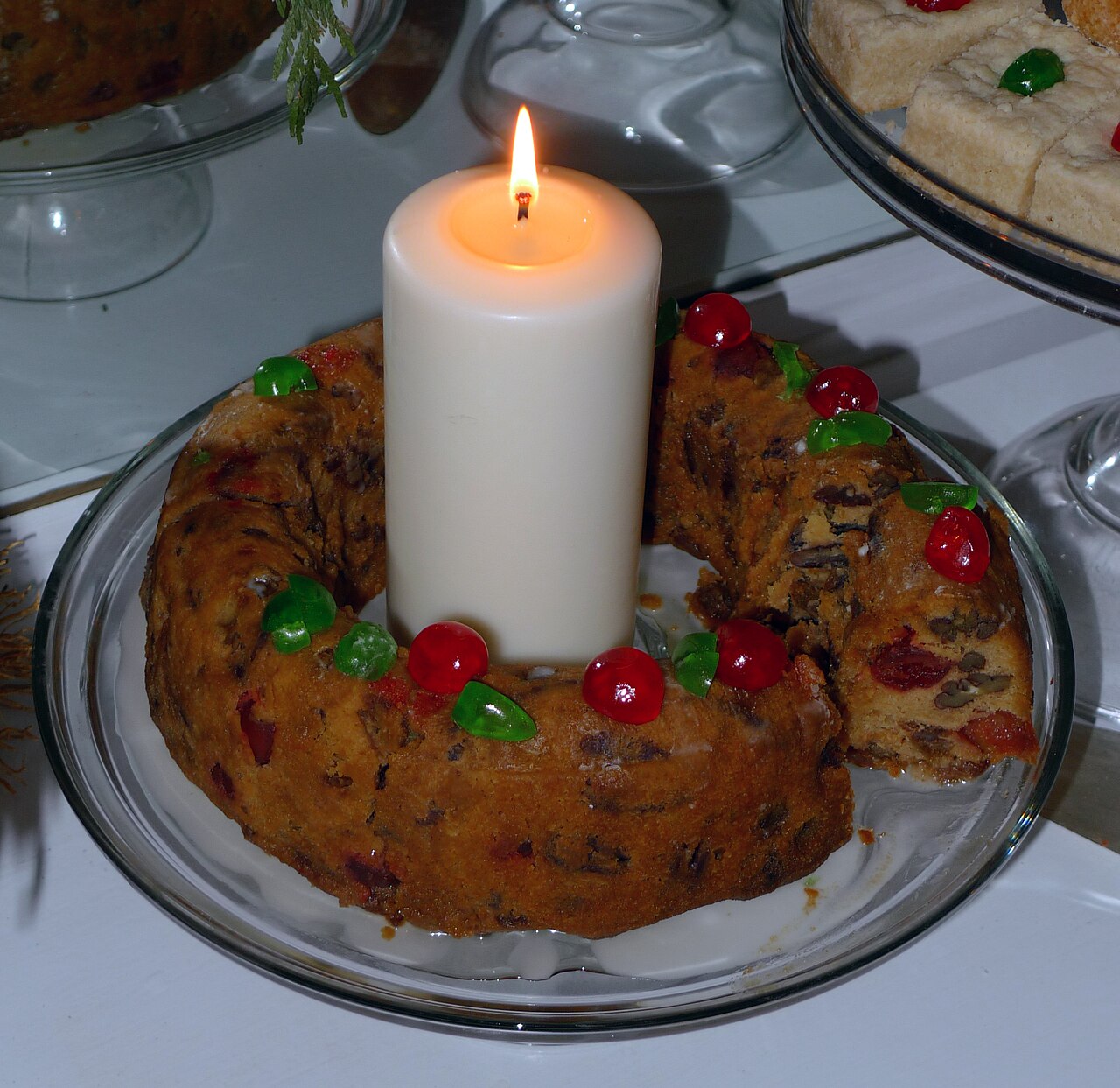 A decorated fruitcake ring with a candle