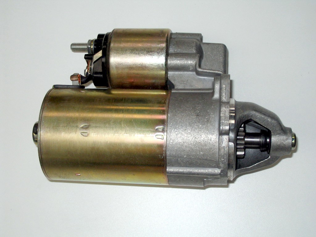 A close-up photograph of an automobile starter motor